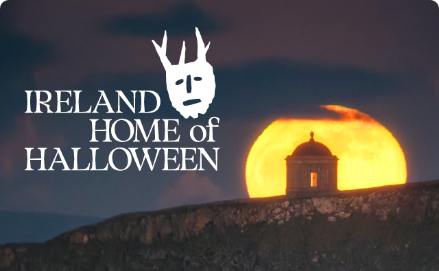 Ireland Home of Halloween – The Mussenden Template is lit by the yellow moon in darkness.