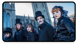 A group of people in period costumes celebrating Bram Stoker Festival.