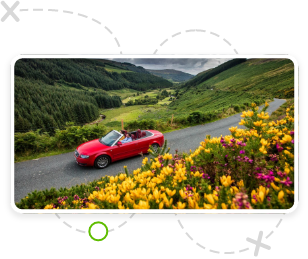 A red car and an idyllic Ireland landscape -Heading out on a road trip